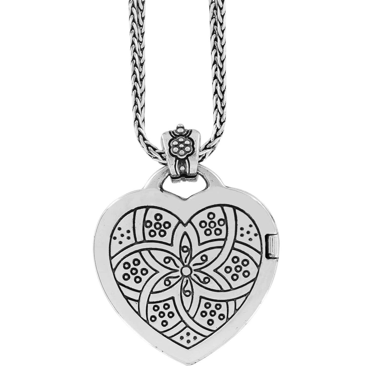 Brighton heart pendant necklace with silver-plated floral engraved design and braided chain on a white background