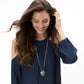 Model wearing a Brighton silver-plated pendant necklace with ornate heart charm on long chain.