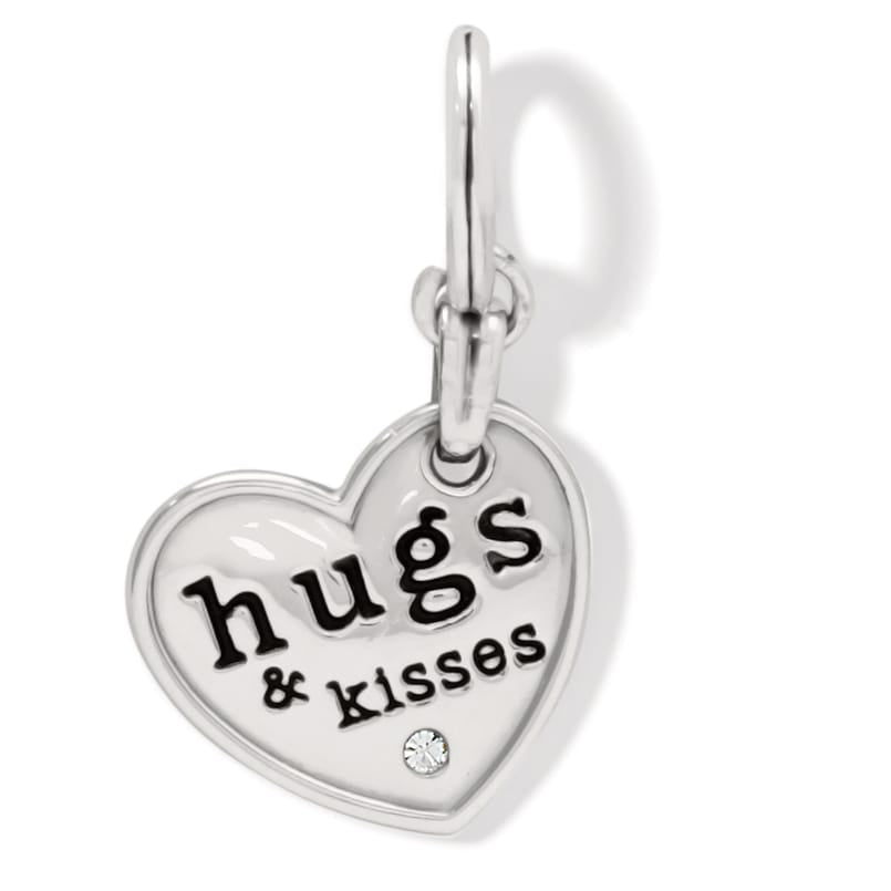 Brighton heart charm with silver-plated finish, engraved hugs and kisses text, and crystal accent on a white background