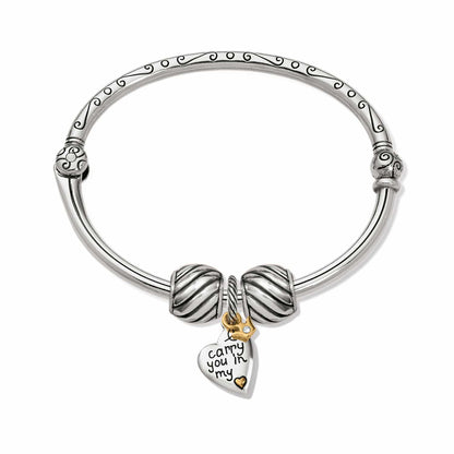 Brighton bangle bracelet with two-tone heart charm engraved with sentiment and silver ribbed beads on a white background