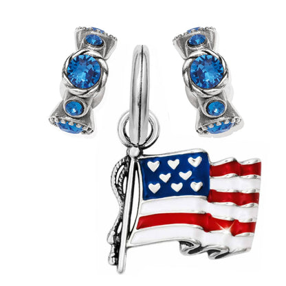 Brighton silver-plated earrings with blue crystals and American flag charm with red, white, and blue enamel on a white background