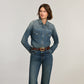 Model wearing a Brighton brown leather belt with tooled detailing and gold-tone rectangular buckle over denim