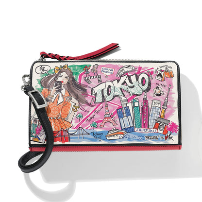 Brighton wristlet pouch with illustrated Tokyo cityscape print, red trim, and black leather strap on a white background