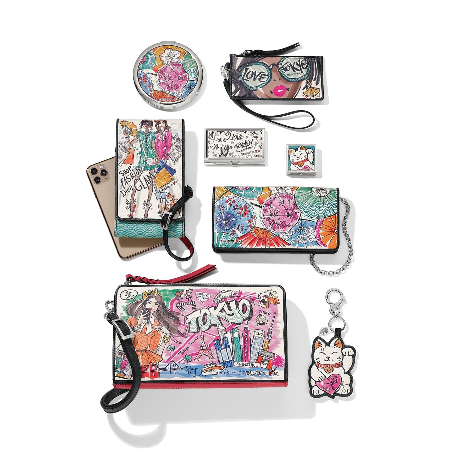 Brighton accessories collection styled with Tokyo-themed illustrated handbags and coordinating compacts and other accessories on white background