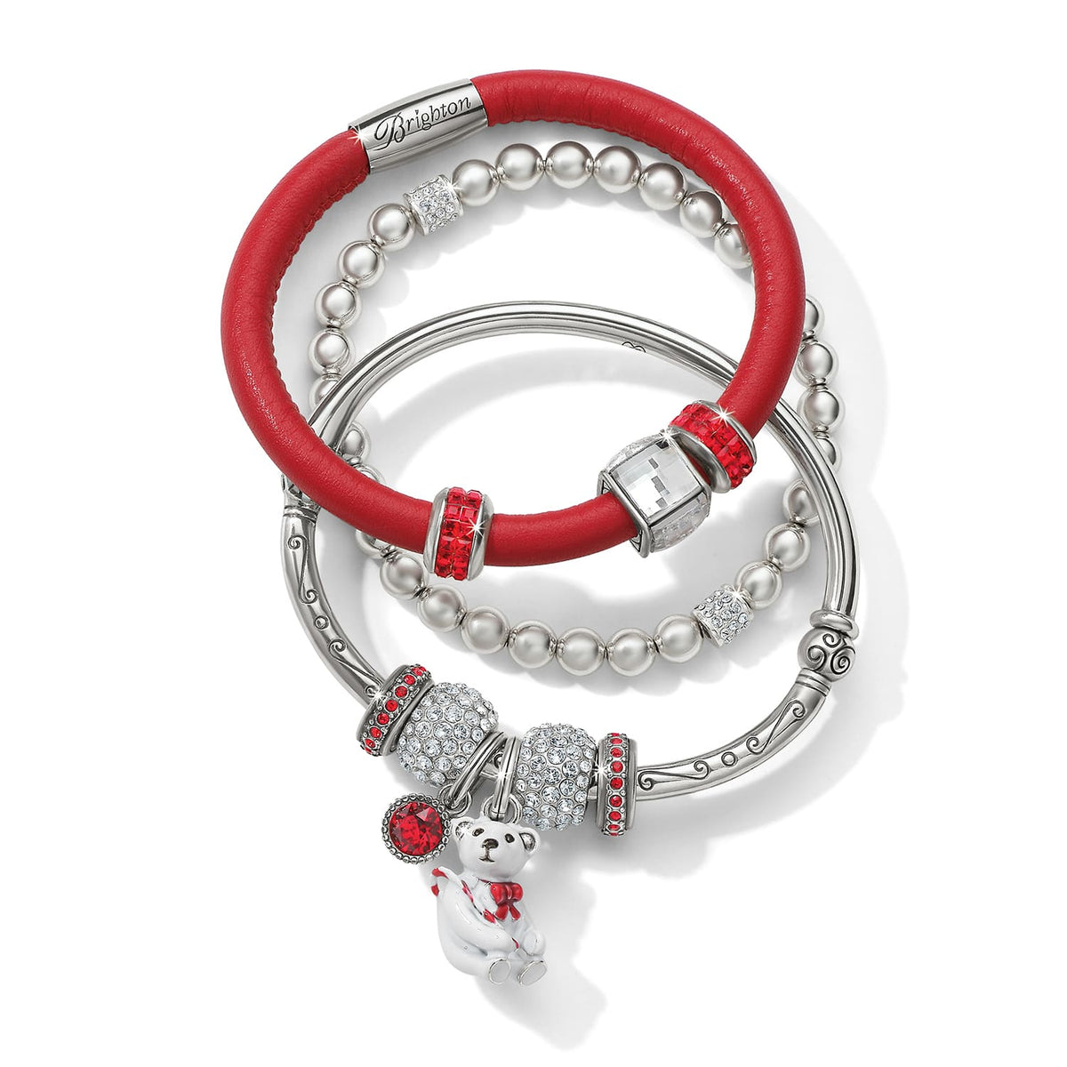 Brighton bracelet set with red leather band, silver-plated beaded bangles, crystal charms, and enamel teddy bear on a white background