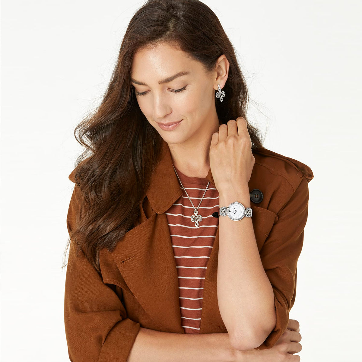 Model wearing a Brighton silver-plated watch with coordinating Brighton knot pendant necklace and drop earrings