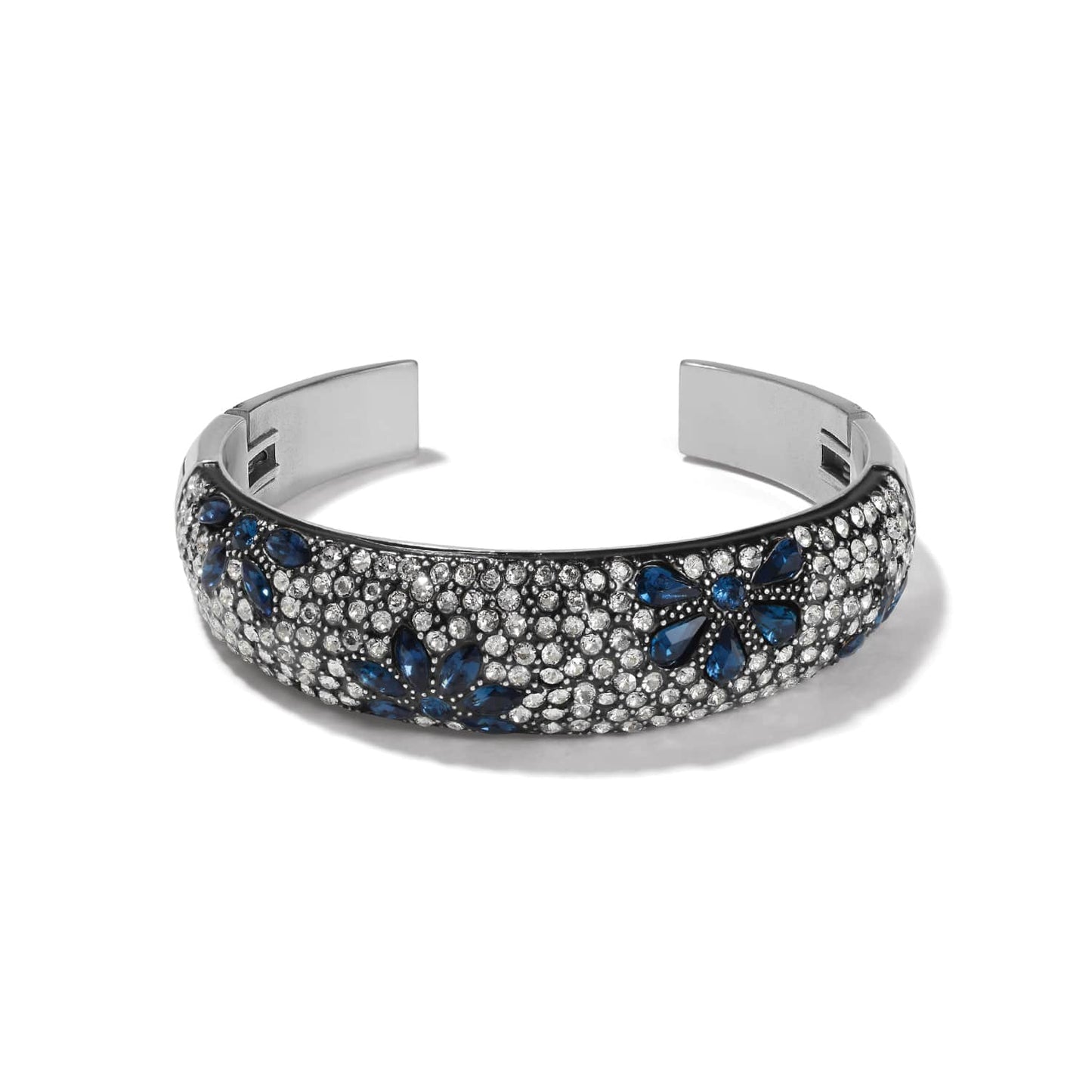 Brighton silver-tone cuff bracelet with blue and clear crystals in floral pattern and black lacquer on a white background