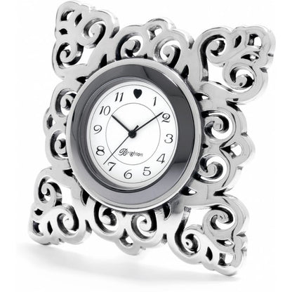 Brighton clock with ornate silver-plated scrollwork frame and white analog dial with black numerals on a white background