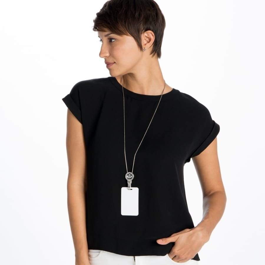 Model wearing a Brighton long silver-plated chain necklace with rectangular white pendant and decorative circular accent