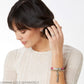 Model wearing a Brighton pink leather charm bracelet with silver-tone tube station and coordinating Brighton accessories