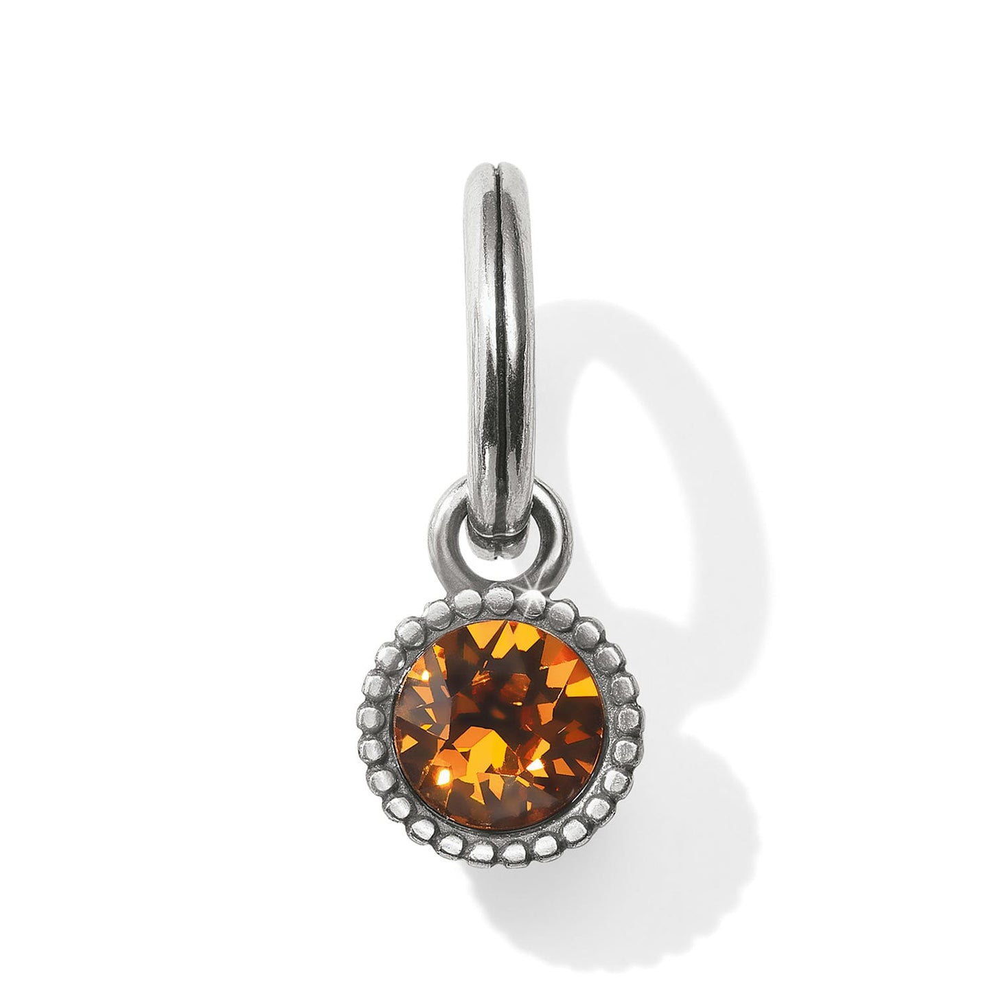 Brighton charm with round amber crystal, beaded silver-tone bezel, and hinged clip closure on a white background