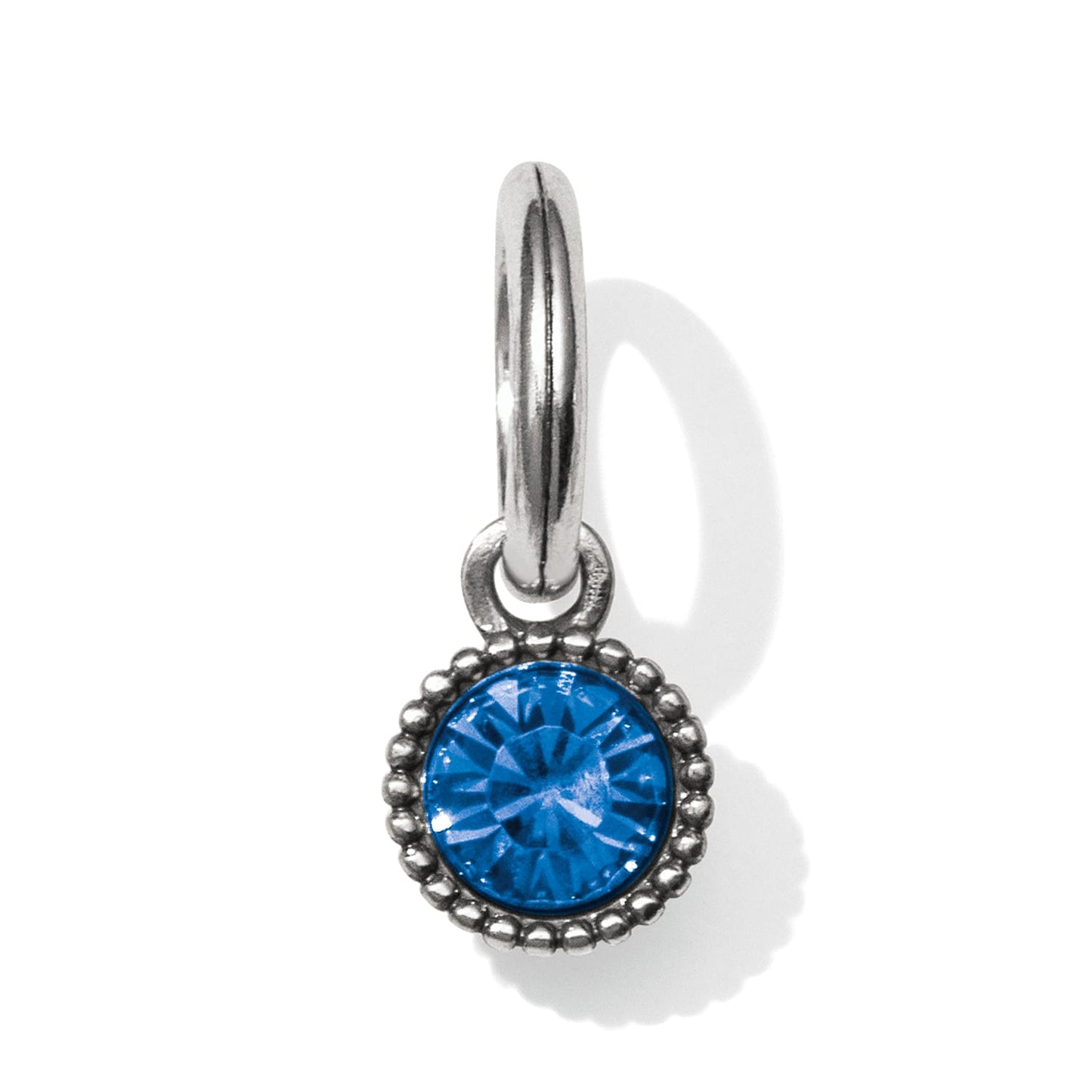 Brighton charm with round blue crystal and silver-tone beaded border on a hinged ring on a white background
