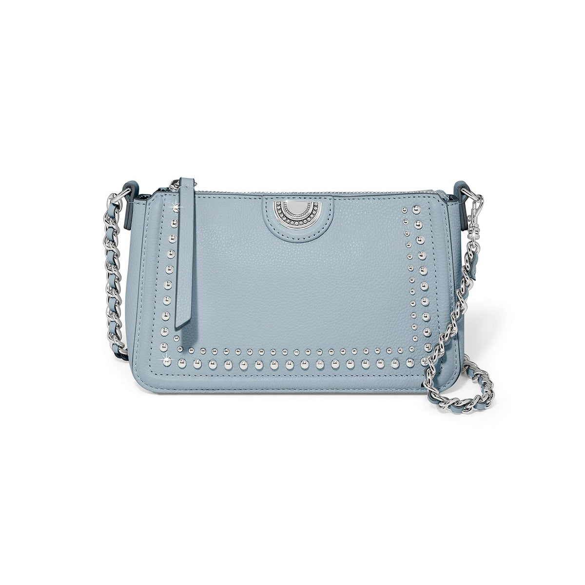 Brighton light blue crossbody handbag with silver-tone studs, medallion accent, and braided chain strap on a white background