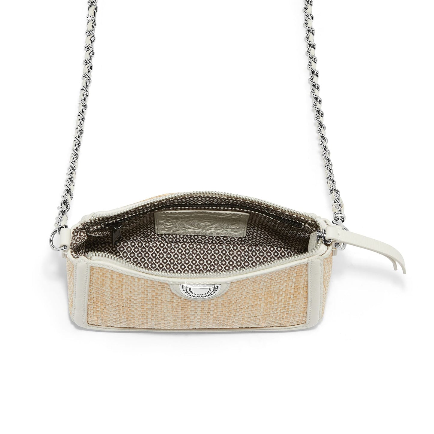 Brighton woven straw crossbody handbag shown open with patterned interior lining and silver-tone chain strap on a white background