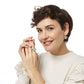 Model wearing Brighton drop earrings with oval pale blue stones paired with a matching gold-plated cocktail ring