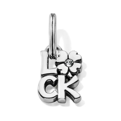 Brighton silver-plated charm spelling luck with a white flower and crystal center on a white background
