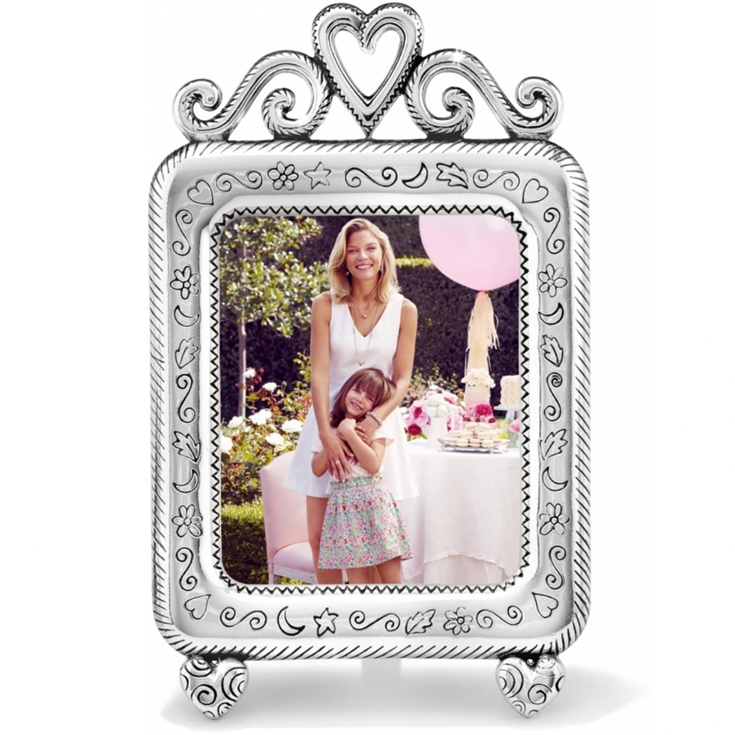 Brighton silver-plated picture frame with heart crown, engraved charms border, and heart-shaped feet on a white background