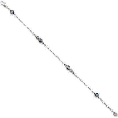Brighton silver-plated bracelet with clustered blue crystal stations and delicate chain links on a white background