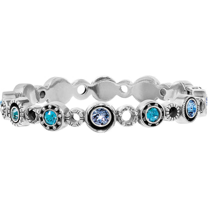 Brighton silver-plated bangle bracelet with alternating blue and aqua crystals in beaded round settings on a white background