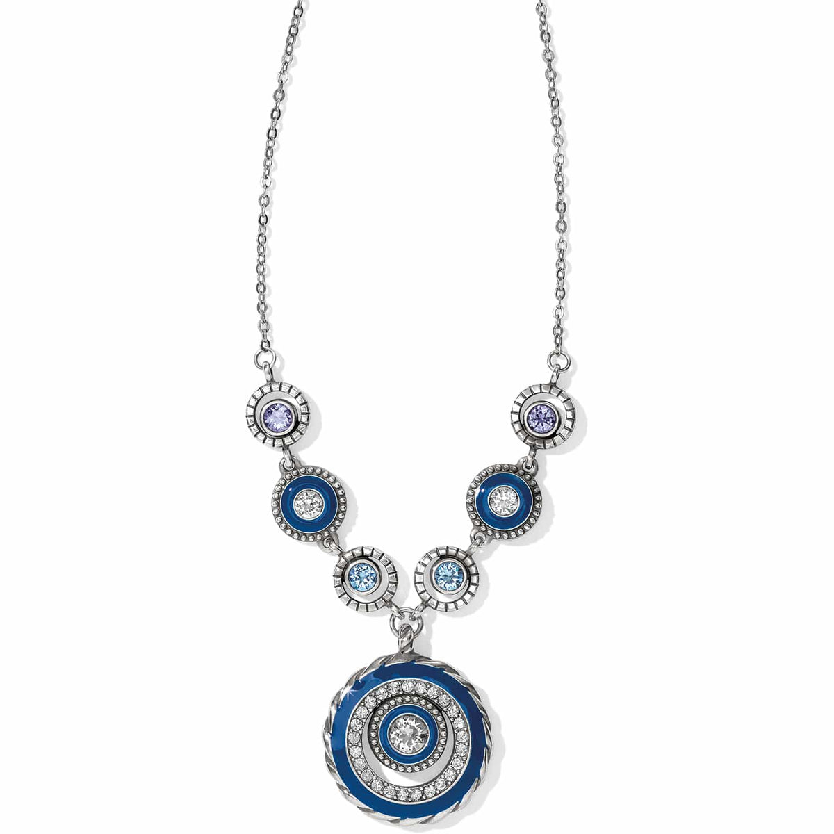 Brighton pendant necklace with silver-plated circular medallion, blue enamel accents, and purple and blue crystals on a white background