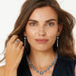 Model wearing a Brighton silver-plated necklace with blue enamel and crystal stations paired with matching drop earrings and ring