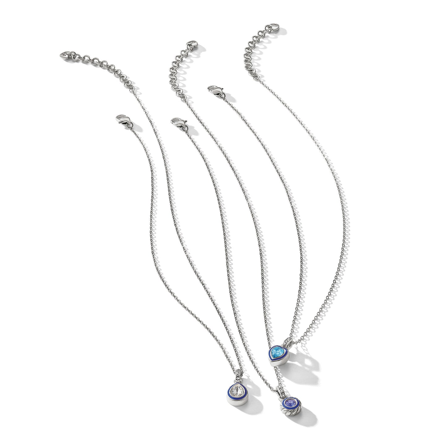 Brighton pendant necklaces with silver-plated chains, crystal, blue enamel, and aqua stone accents on a white background