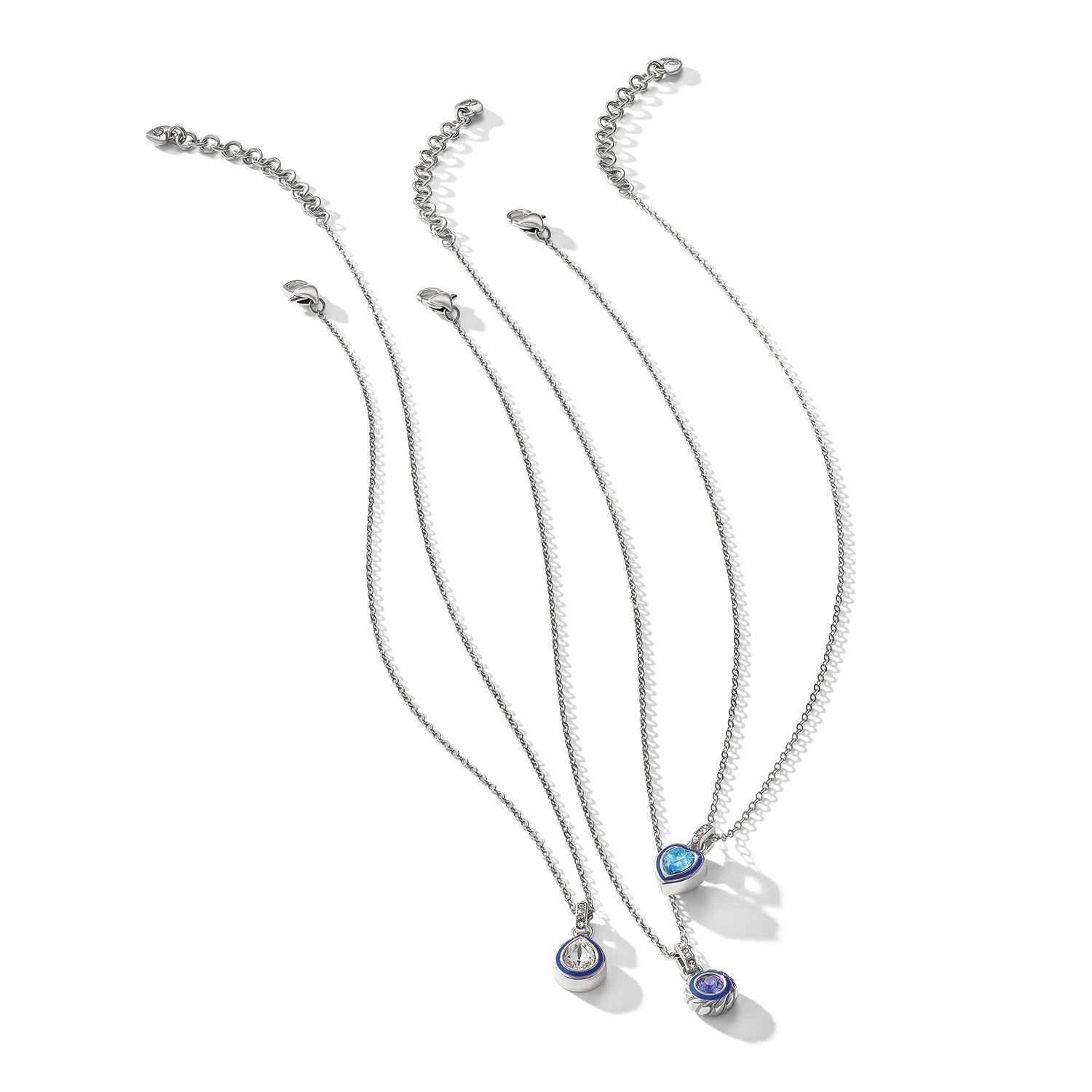 Brighton pendant necklaces with crystal, blue enamel, and silver-plated accents on a white background