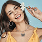 Model wearing a Brighton silver-plated butterfly pendant necklace with multicolored crystals and coordinating Brighton accessories