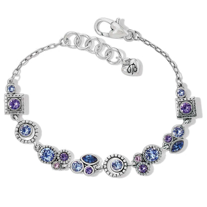 Brighton bracelet with blue and purple crystals in silver-plated round and square settings on a white background