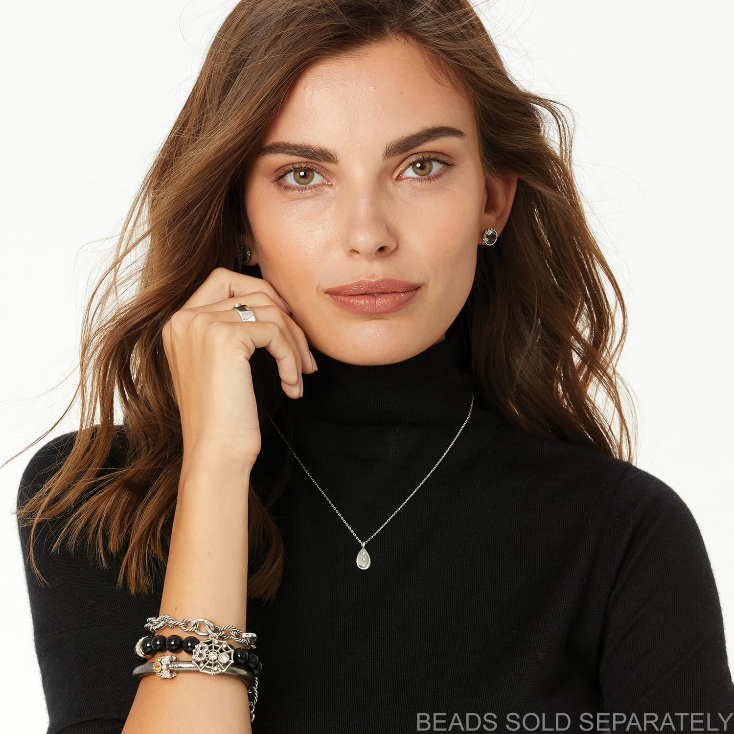 Model wearing a Brighton silver-plated teardrop pendant necklace with coordinating Brighton accessories including earrings, ring, and bracelets