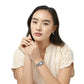 Model wearing a Brighton silver-plated watch with rectangular dial and scrollwork bracelet, paired with heart drop earrings