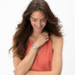 Model wearing a Brighton silver-plated watch with rectangular dial and decorative scrollwork band on wrist