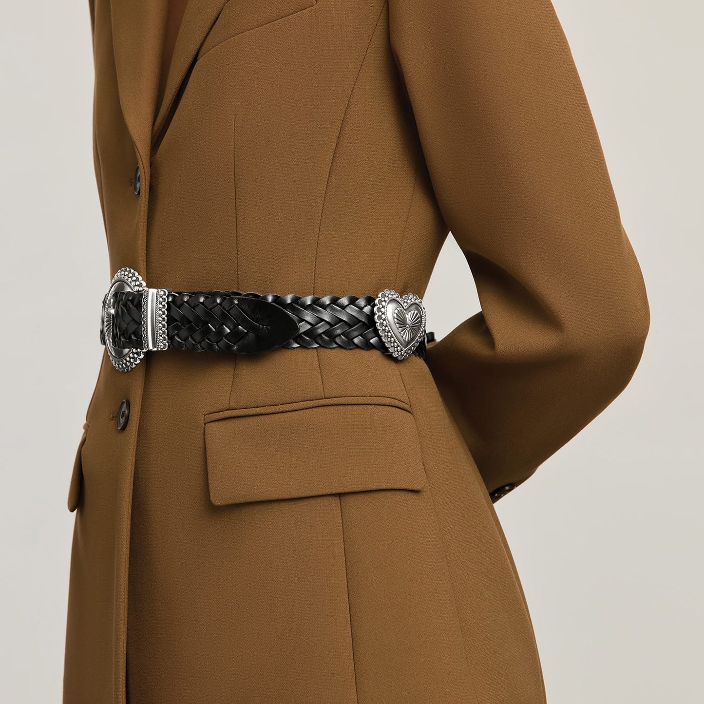 Model wearing a Brighton black braided leather belt with silver-tone engraved buckle and heart-shaped keeper
