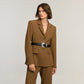 Model wearing a Brighton black braided leather belt with ornate silver-tone round buckle over a brown blazer