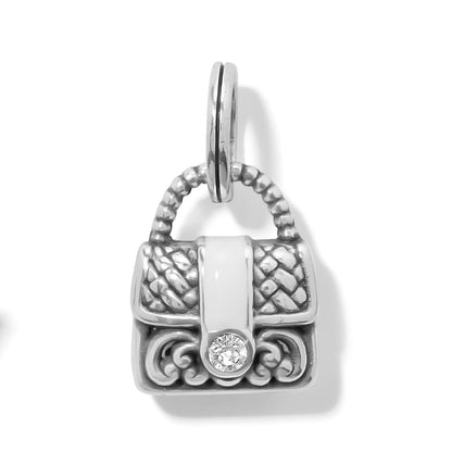 Brighton handbag charm with silver-plated woven design, white enamel strap, and crystal accent on a white background