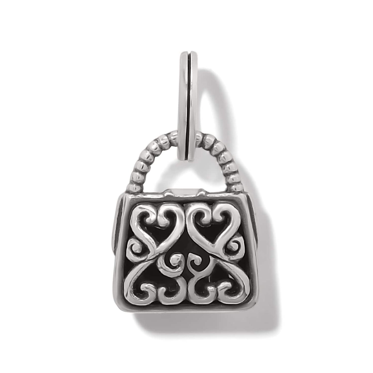 Brighton handbag-shaped charm with silver-plated scrollwork hearts over black enamel and beaded handle on a white background