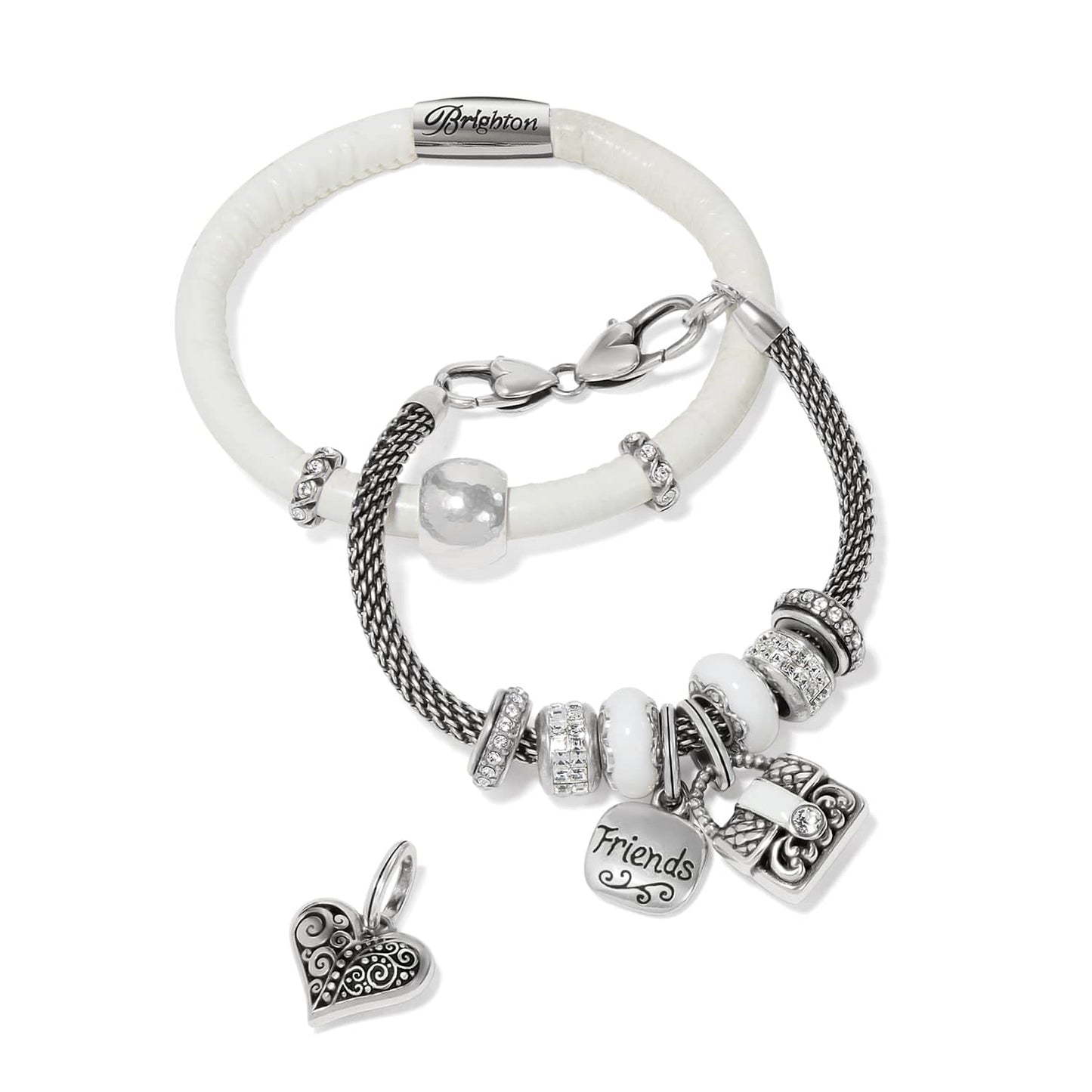 Brighton bracelets in silver-plated mesh and white enamel with crystal accents, friends charm, and heart charm on a white background