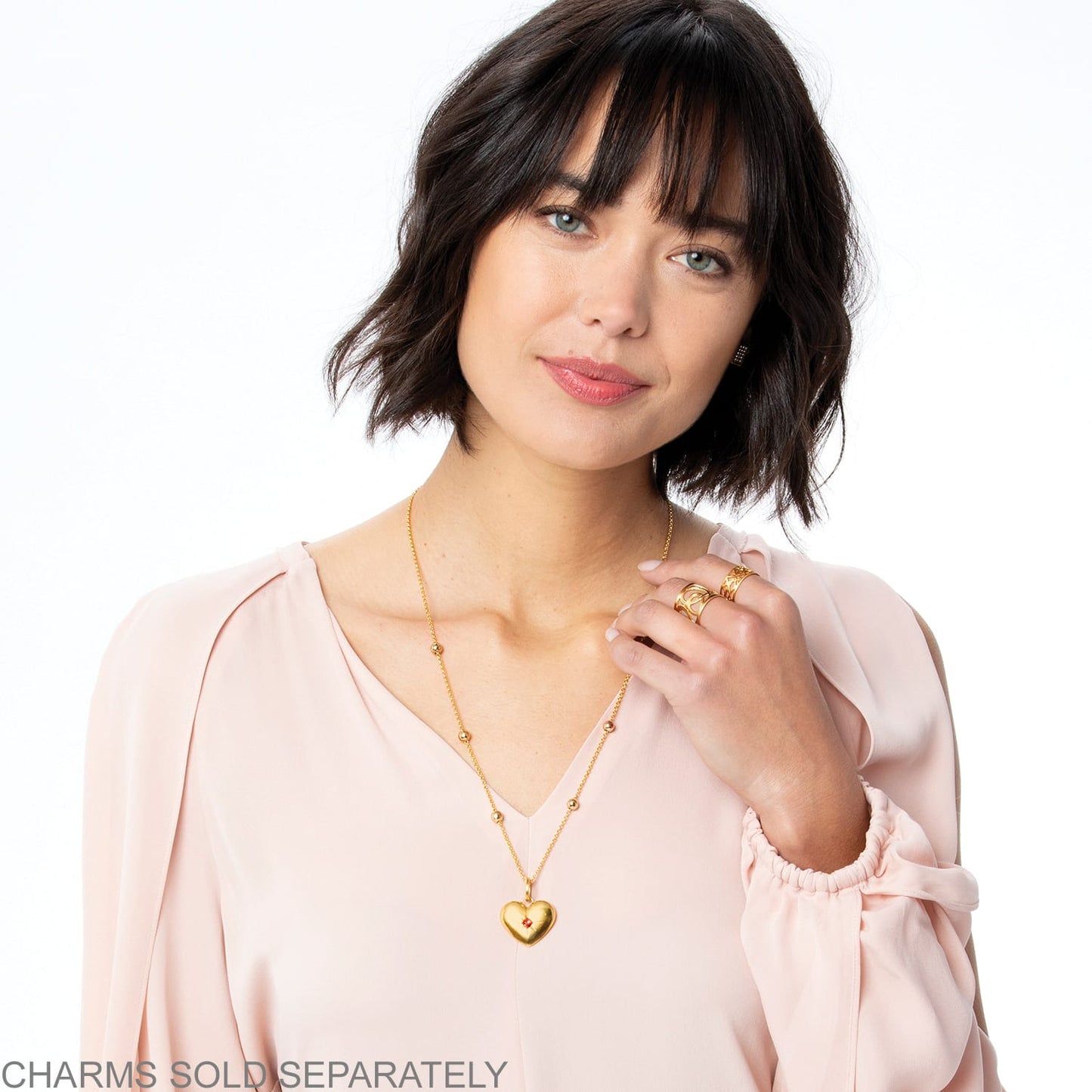 Model wearing a Brighton gold-plated heart pendant necklace with beaded chain stations and small crystal accent
