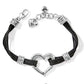 Brighton bracelet with black cord strands, silver-plated heart centerpiece, scroll accents, and heart charm on a white background