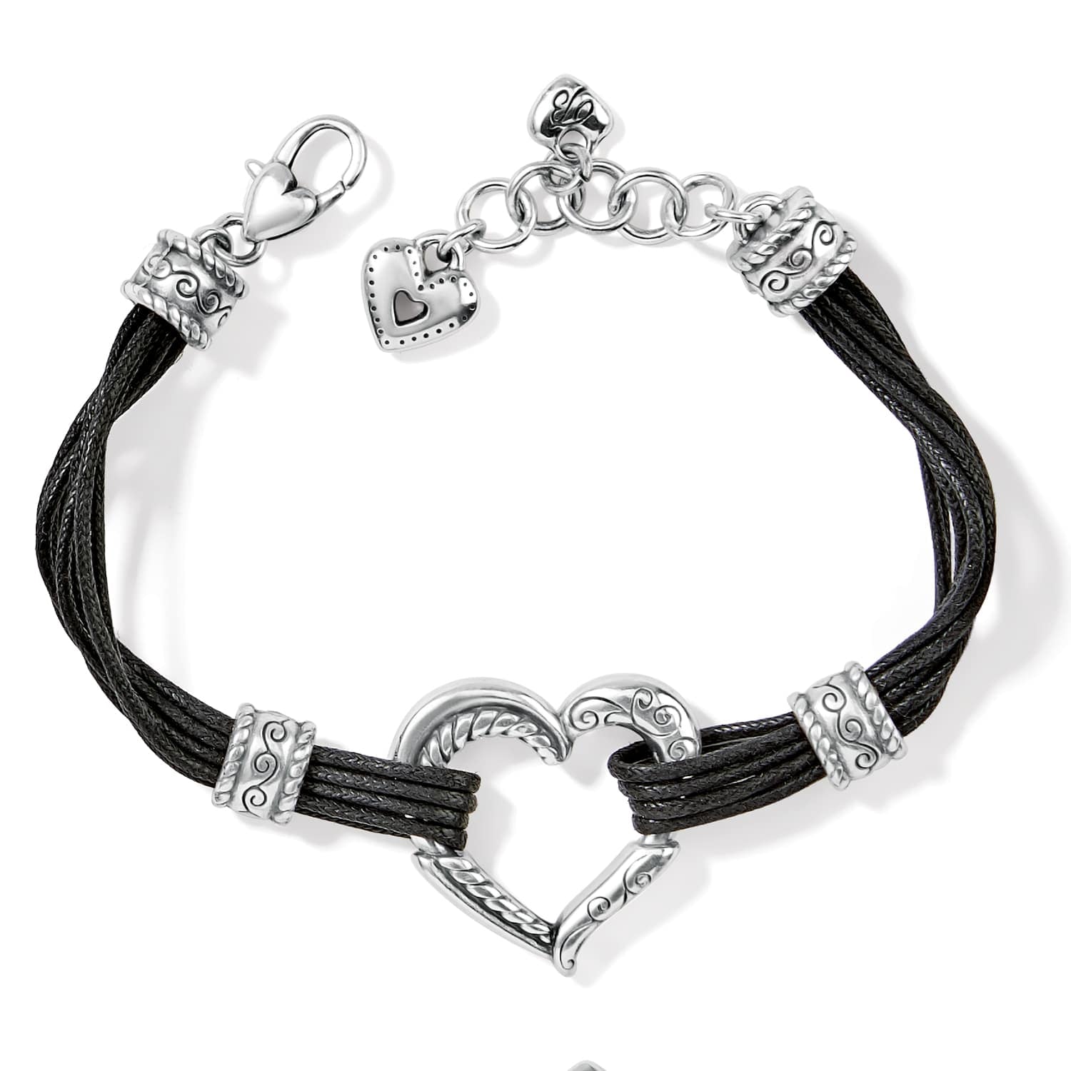 Brighton bracelet with black cord strands, silver-plated heart centerpiece, scroll accents, and heart charm on a white background