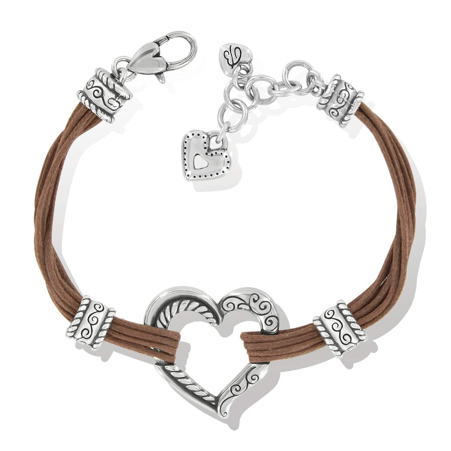 Brighton bracelet with brown cord strands, silver-plated heart centerpiece, scrollwork spacers, and heart charm on a white background