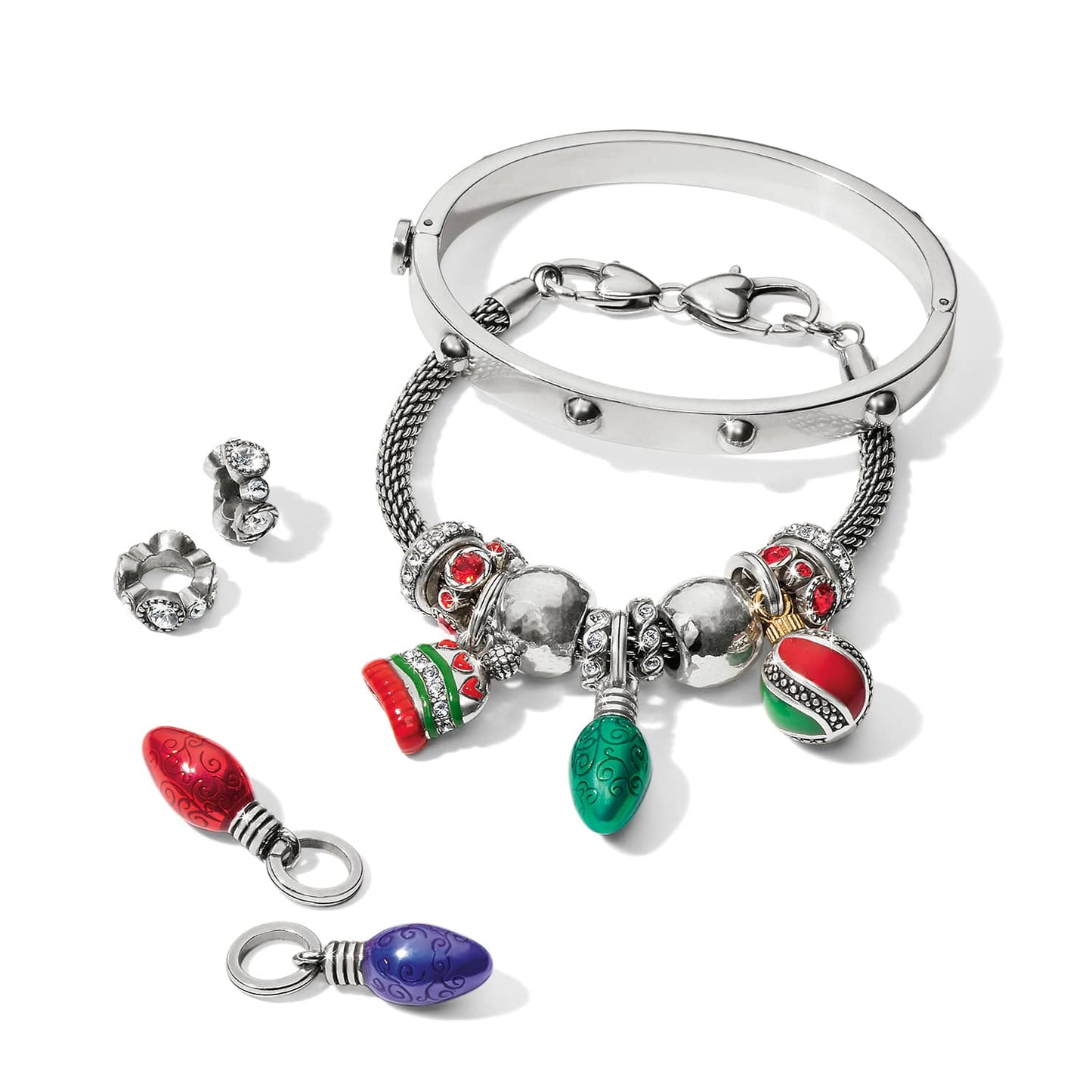 Brighton silver-plated bangle bracelets styled with enamel Christmas light charms and crystal spacer beads on white background