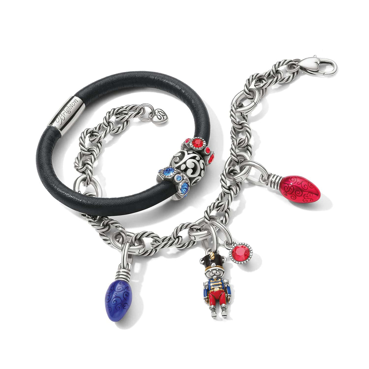 Brighton bracelets with black leather band, silver-plated chain, enamel nutcracker and light bulb charms on a white background