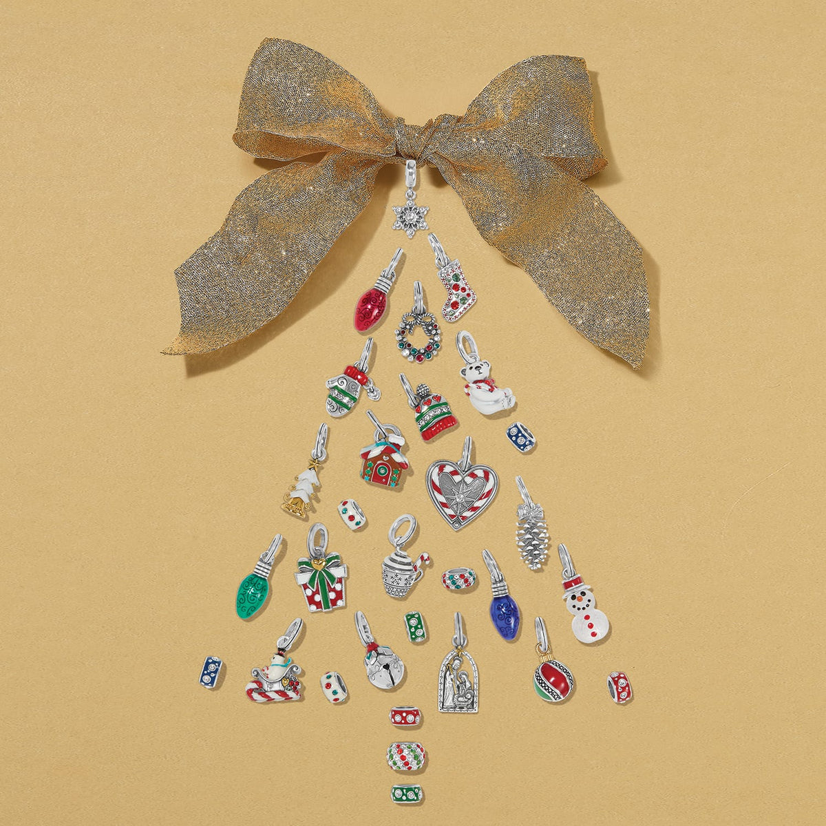 Brighton silver-plated enamel holiday charms styled with a gold bow in a Christmas tree arrangement