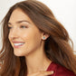 Model wearing a Brighton Christmas tree stud earring with blue and clear crystals in two-tone finish