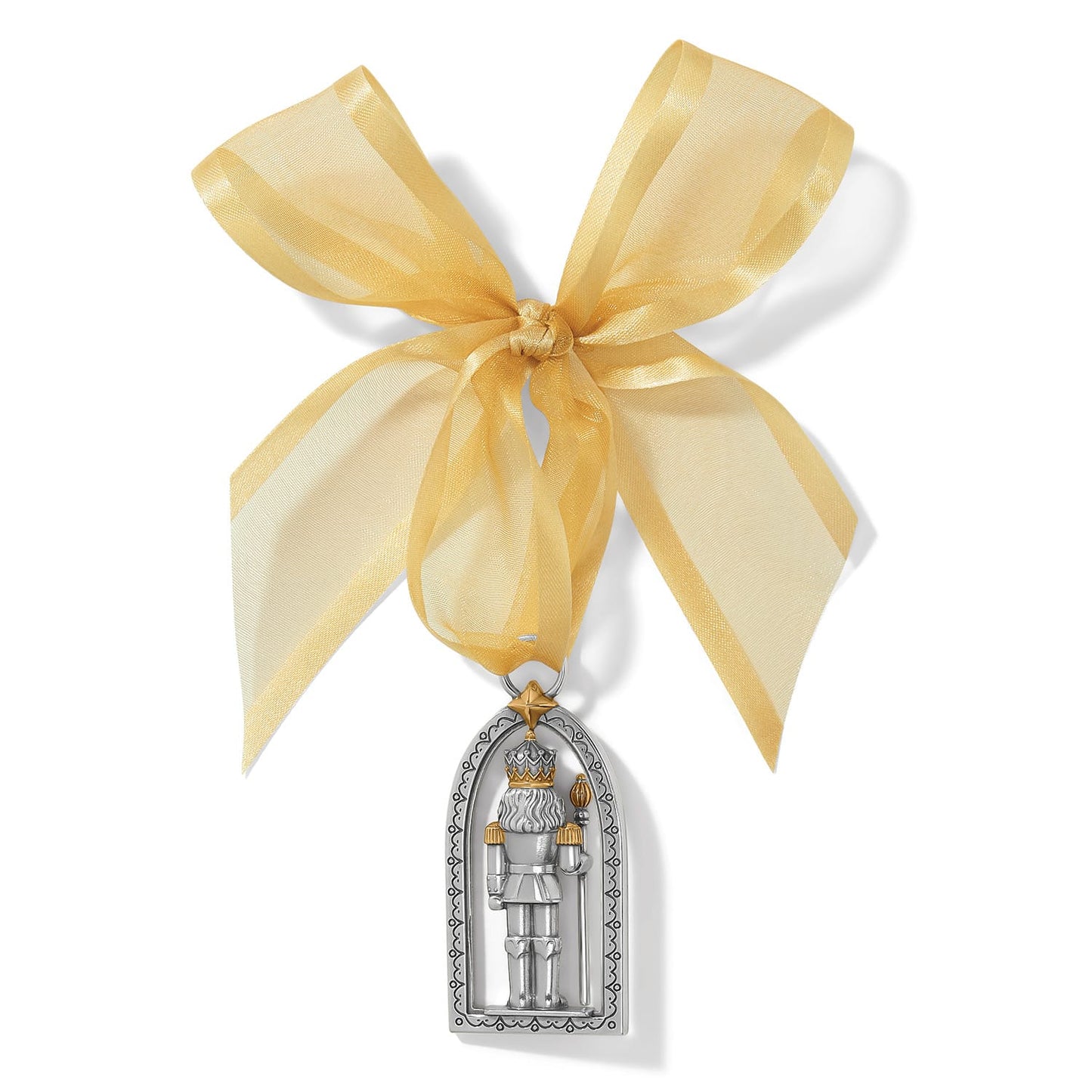 Brighton nutcracker ornament with two-tone silver and gold finish in arched frame with gold ribbon bow on a white background
