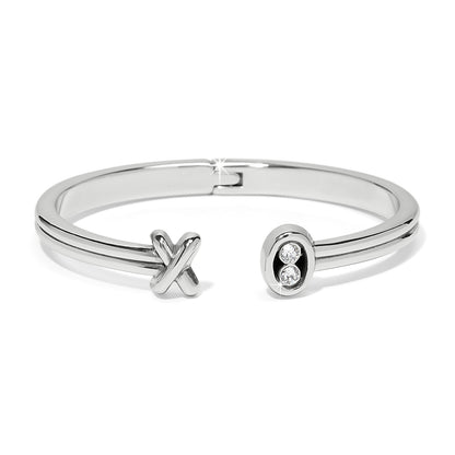 Brighton hinged cuff bracelet with silver-plated finish, X motif, and oval crystal accent end on a white background