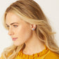 Model wearing a Brighton silver-plated stud earring featuring a small bird in flight design