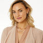 Model wearing Brighton silver-plated hoop earrings paired with a delicate silver-plated chain necklace featuring a crystal pendant