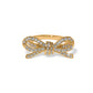 Brighton ring with gold-tone bow design and pavé crystal accents across ribbon loops on a white background